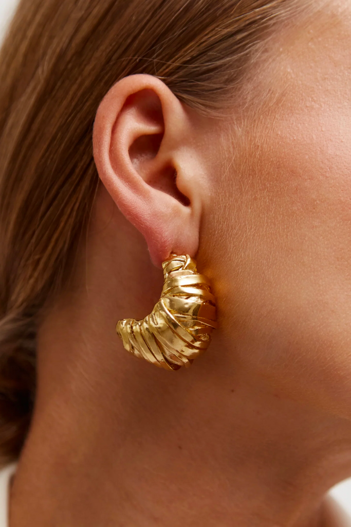  The Blass earrings are a bold and sophisticated statement piece with intricate textures and shapes, perfect for anyone looking to add a touch of edgy glamour to their wardrobe.