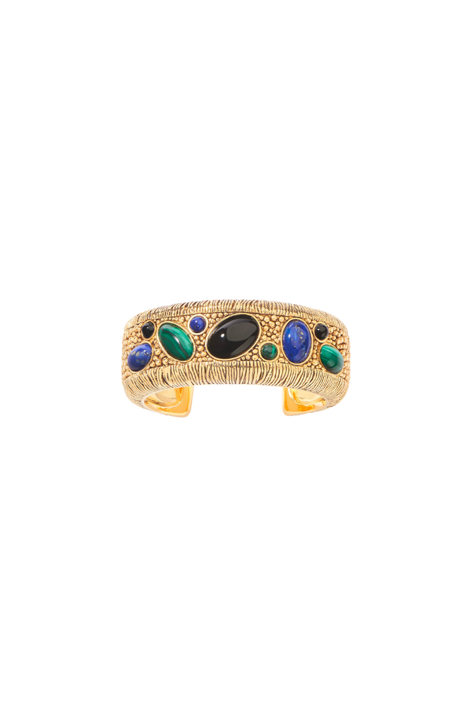 Aurélie Bidermann's Britania collection is a stunning combination of royalty and preppy styles, featuring a badge design adorned with onyx, malachite, and lapis lazuli cabochons, available in a cuff, bracelet, ring, and long necklace that transforms into a brooch.