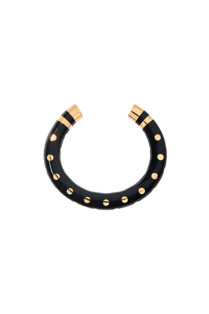 The Positano bracelet from Aurelie Bidermann is a chic and sophisticated accessory inspired by the iconic striped umbrellas of the Amalfi coast, featuring a unique design that combines black dots with classic stripes.