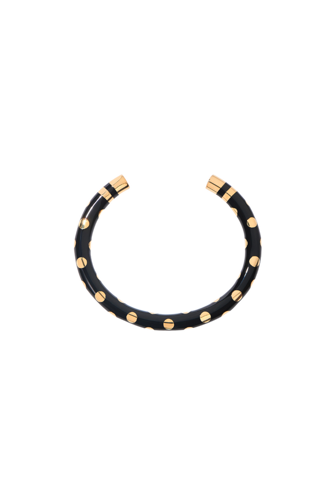 The Positano bracelet from Aurelie Bidermann is a chic and sophisticated accessory inspired by the iconic striped umbrellas of the Amalfi coast, featuring a unique design that combines black dots with classic stripes.
