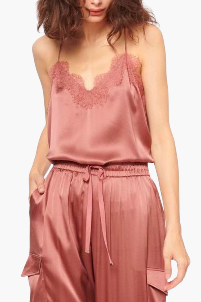 The Racer Charmeuse Cami by Cami NYC is a versatile and luxurious wardrobe essential made from silk sandwash charmeuse, featuring a delicate V-neckline with feminine French lace trimming and a relaxed fitting bodice, perfect for any occasion and available in feminine pink.