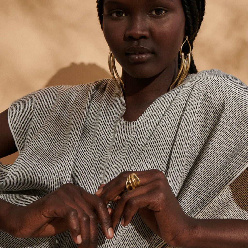 Woman wearing a patterned garment with a blurred  Ranunculus Ring Ariana Boussard-Reifel