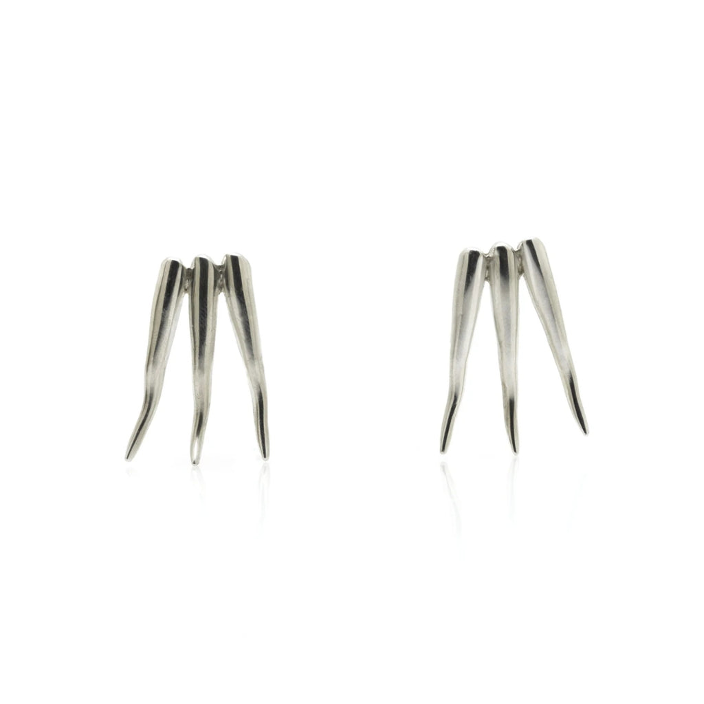 Pair of silver spike earrings on a white background
