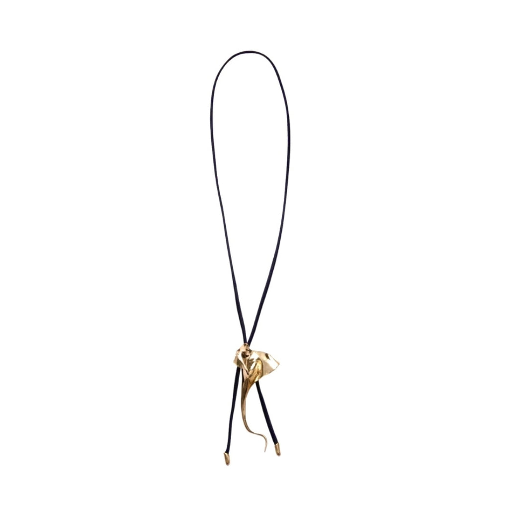 A stylish gold pendant on a black cord necklace.
