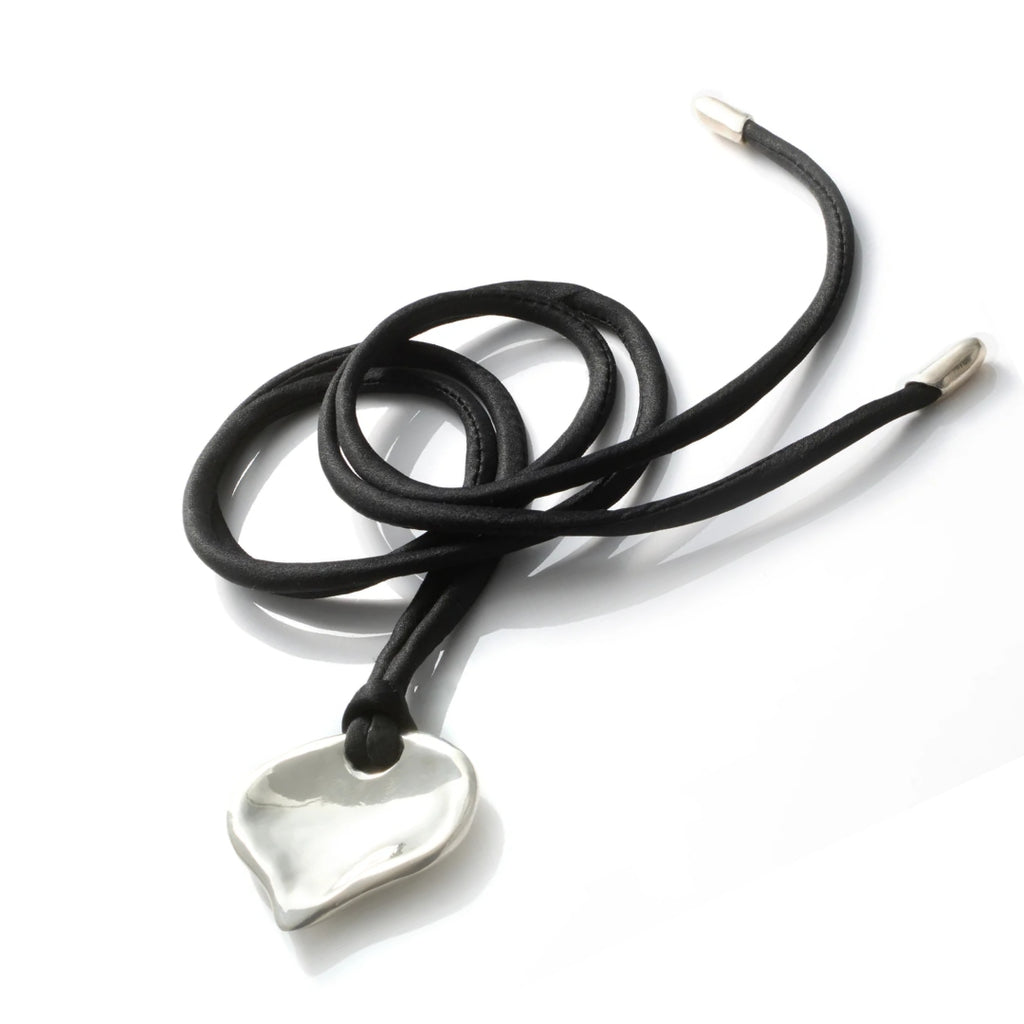 Black cord necklace with a silver pendant on a white background