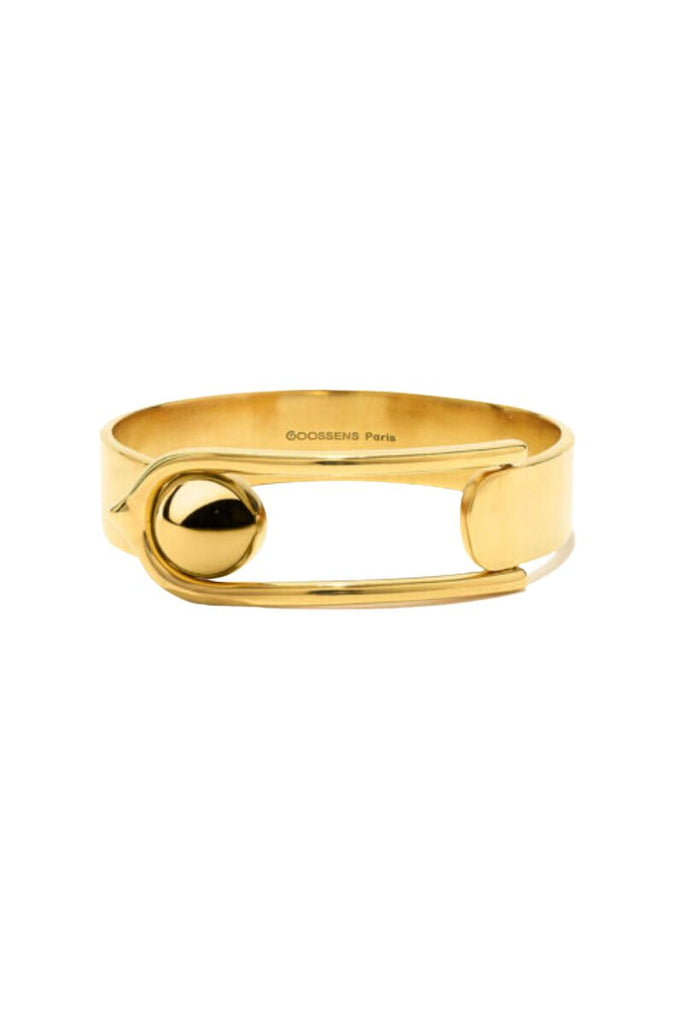 The Boucle GM Bracelet by Goossens Paris is a sleek and modern bracelet made from brass soaked in a 24-carat gold bath, featuring the distinctive House of Goossens clasp and a light and pleasant design that can be mixed and matched for a unique effect.