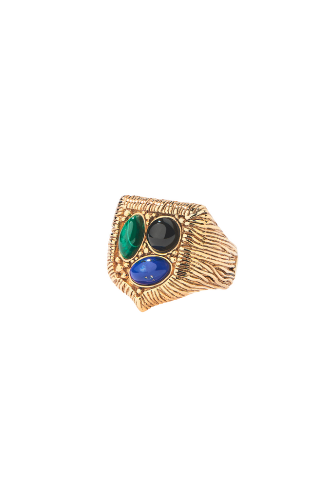  Aurélie Bidermann's Britania collection is a stunning combination of royalty and preppy styles, featuring a badge design adorned with onyx, malachite, and lapis lazuli cabochons, available in a cuff, bracelet, ring, and long necklace that transforms into a brooch.
