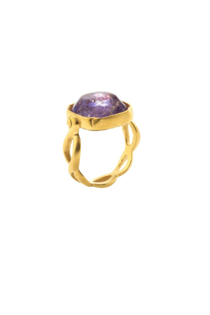 The Cabochons Squared Ring by Goossens Paris is a timeless statement piece of jewelry with hand-dyed rock crystal stones, tempered brass ring soaked in 24-carat gold bath, and a square cabochon centerpiece made of rock crystal tinted with purple, showcasing the brand's fine craftsmanship and attention to detail.