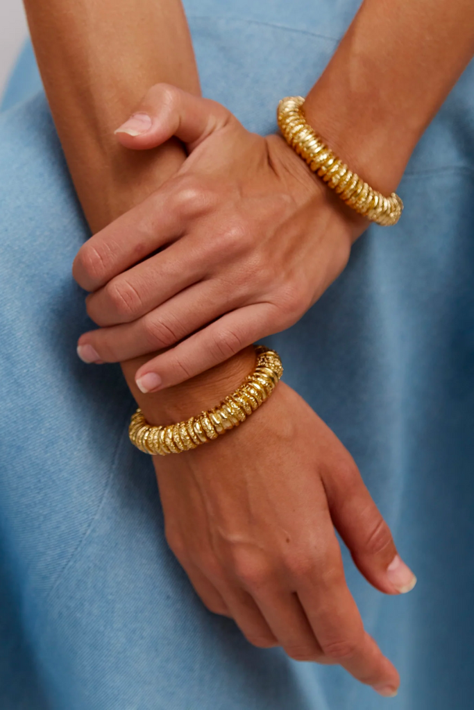 The Capital Bracelet by Paola Sighinolfi is a handmade, gold jewelry piece with a modern, minimalistic, and sophisticated design that complements a wide range of styles.