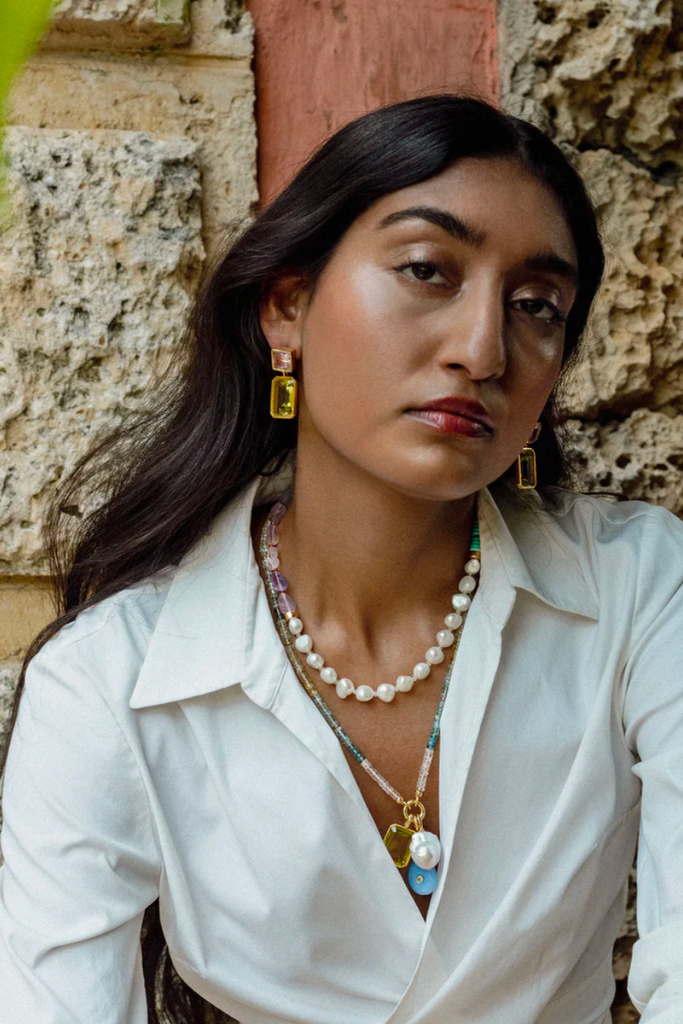 Embrace the captivating coastal charm of the Chama Necklace in Amethyst by Lizzie Fortunato, featuring a colorful beaded collar design of natural gemstones and a gold-plated brass toggle closure.