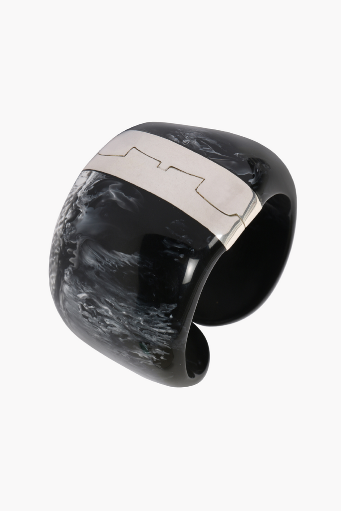 Elevate any outfit with the stunning Resin Bold Stone Cuff in Black Marble by Dinosaur Designs, featuring a unique swirl pattern and brass hinge.