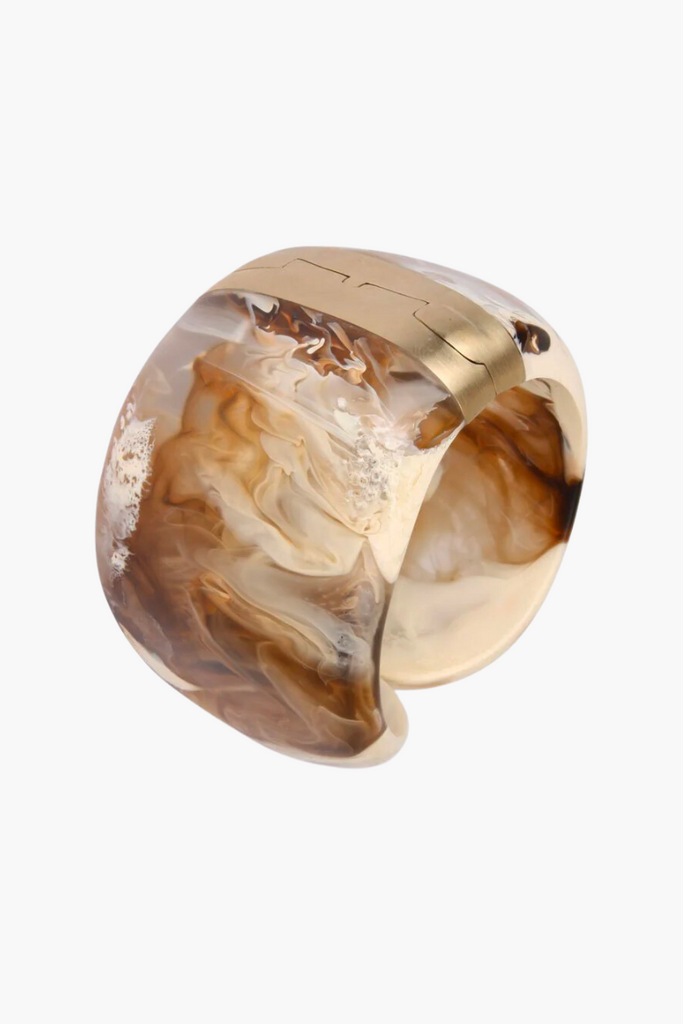 Elevate any outfit with the stunning Resin Bold Stone Cuff in Light Horn by Dinosaur Designs, featuring a unique swirl pattern and brass hinge.