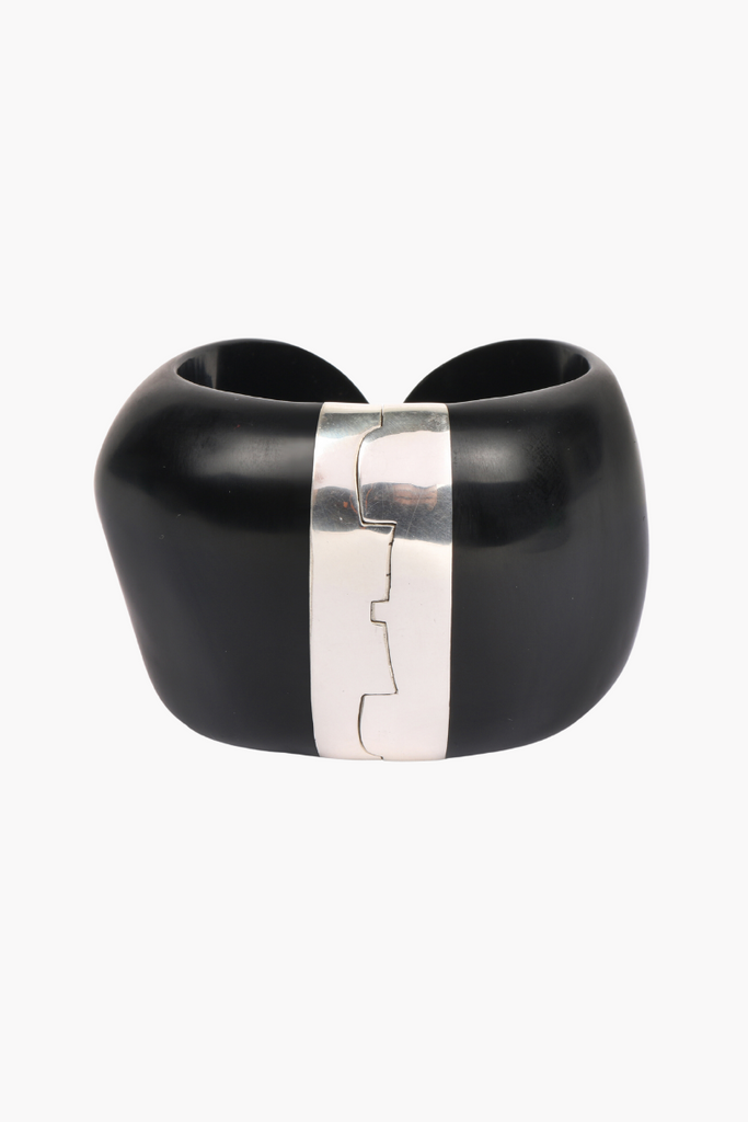 Elevate any outfit with the stunning Resin Bold Stone Cuff in Silver Black by Dinosaur Designs, featuring a unique swirl pattern and brass hinge.