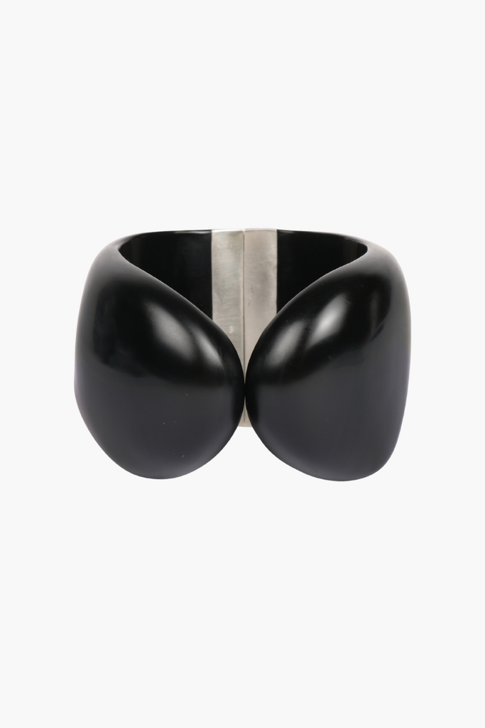 Elevate any outfit with the stunning Resin Bold Stone Cuff in Silver Black by Dinosaur Designs, featuring a unique swirl pattern and brass hinge.