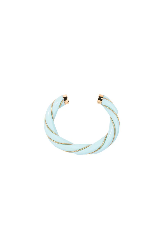 The Diana twisted bangle by Aurelie Bidermann. In a beautiful baby blue color, this bangle adds a touch of freshness and playfulness to any outfit. The twisted design adds a unique and elegant touch, making it a versatile accessory that can be dressed up or down.
