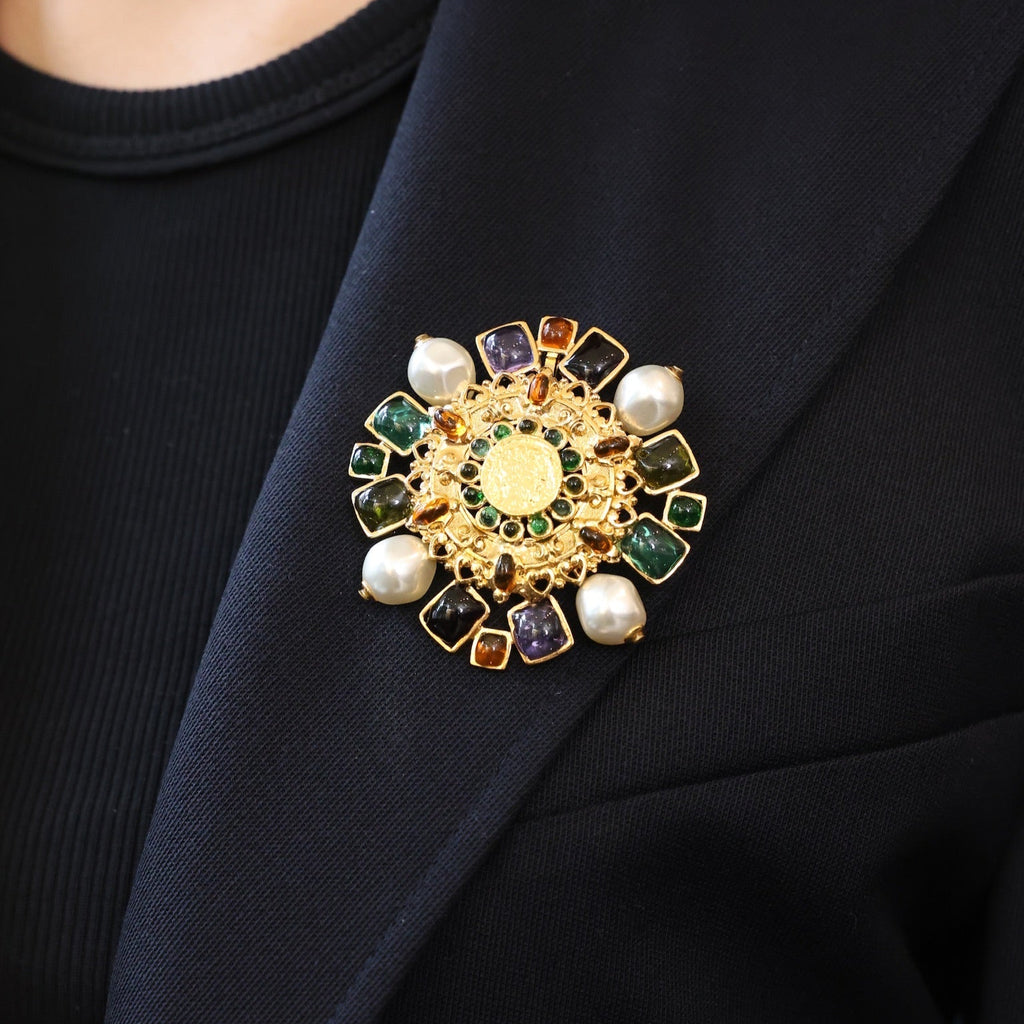 Close-up of a decorative brooch on a dark blazer