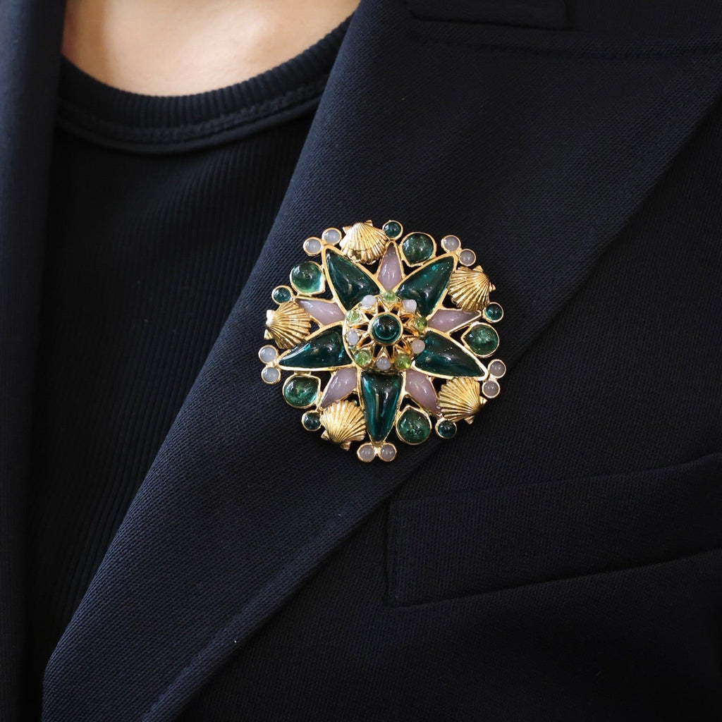 Close-up of a decorative brooch on a dark blazer