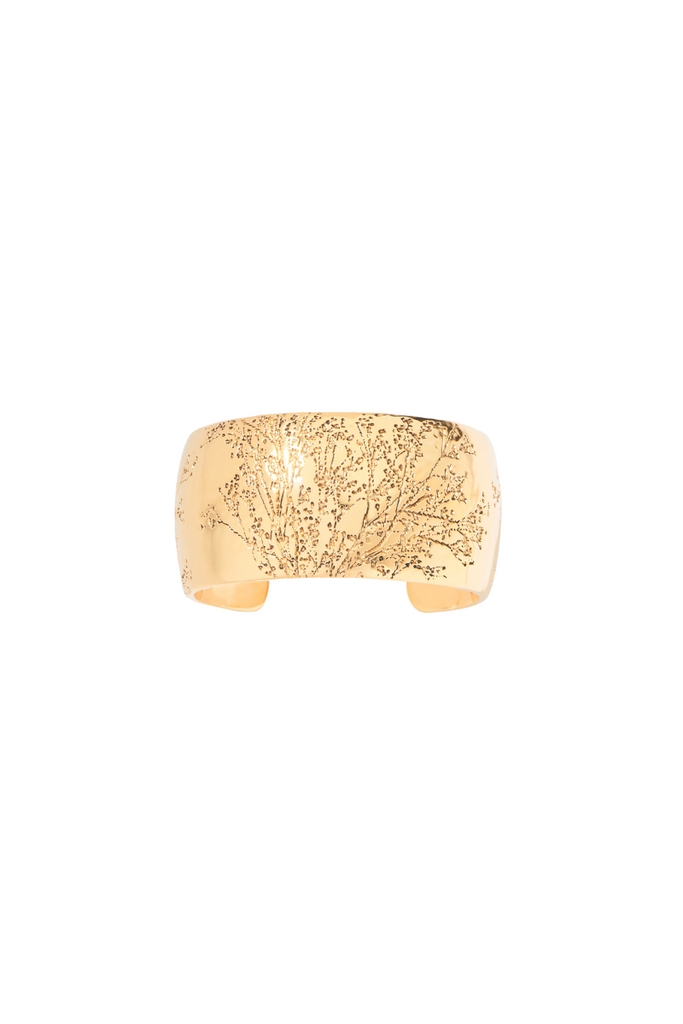 The Hermione Cuff from Aurélie Bidermann's collection features delicate flowers printed into the golden metal, capturing the beauty of an English garden.