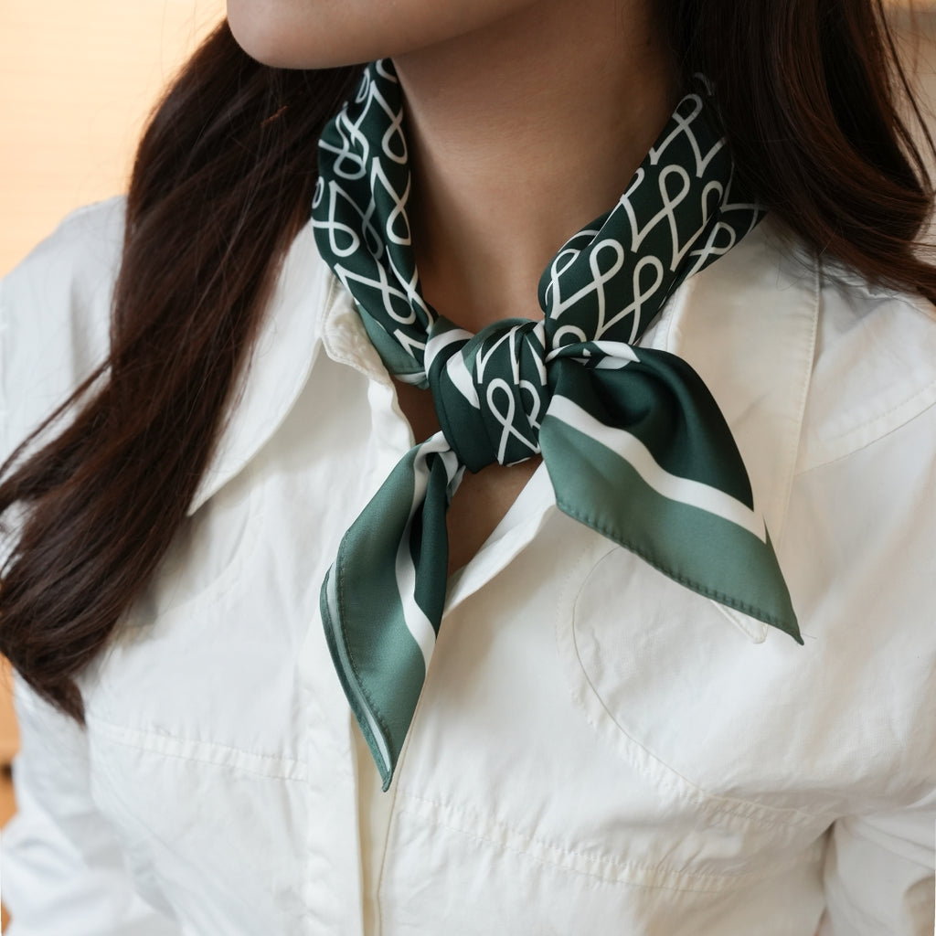 Person wearing a green and white patterned scarf around their neck against a neutral background Anniversary Limited Edition Gift Set - Timeless Anniversary Necklace Green Pendant by LOUVE