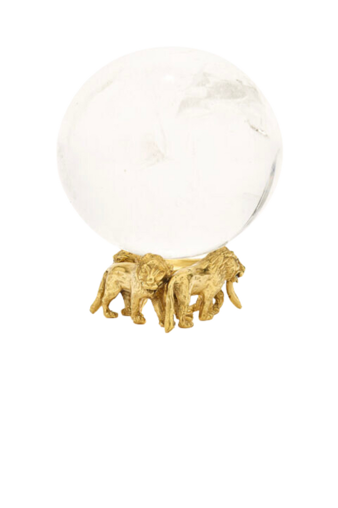  The Lion Object from the House of Goossens is an iconic masterpiece that exudes luxury and sophistication, crafted in brass and 24-carat gold with three majestic lions supporting a rock crystal ball, symbolizing power and strength.