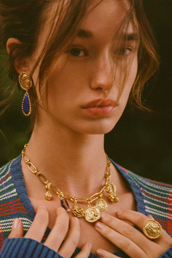 Aurélie Bidermann's Lucius earrings are a stunning tribute to the famous lions of Trafalgar Square and Buckingham Palace, featuring lapis lazuli and a central motif on a necklace.