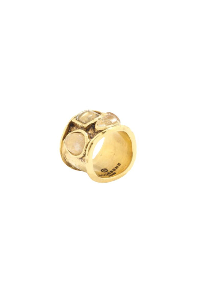 The Mini Cabochons Ring is a delicate and modern piece of jewelry with a colorful design resembling a rainbow, crafted from brass soaked in 24-carat gold bath and featuring natural rock crystal cabochons, making it a timeless and elegant addition to any collection.