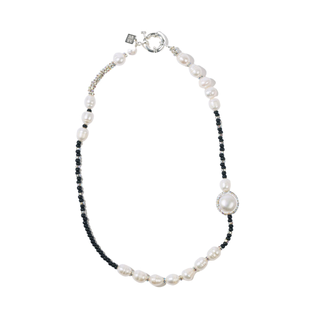 Necklace with pearls and black beads on a white background