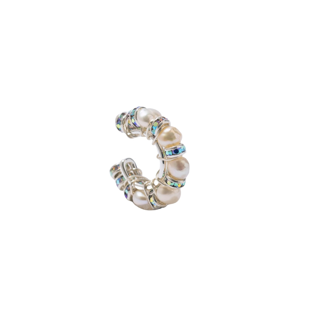 Silver ring with pearls and gemstones on a white background