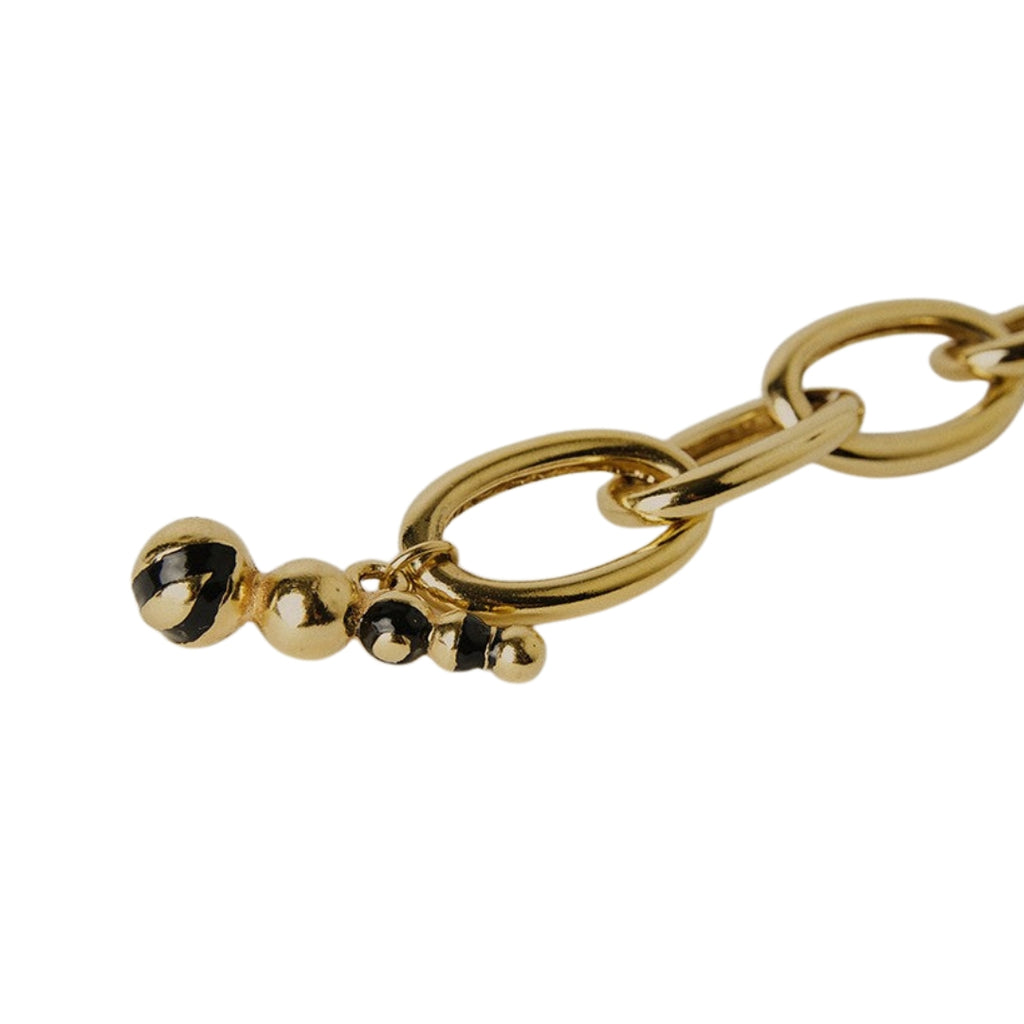 Gold bracelet with interlocking links and  black enamel clasp