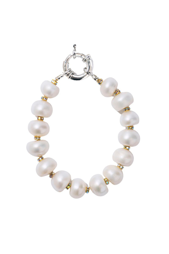 The Pearl Diamond Bracelet from Pearl Octopuss.y is a luxurious and elegant accessory featuring oversized pearls and silver-plated crystals in a contemporary design, perfect for elevating any outfit.