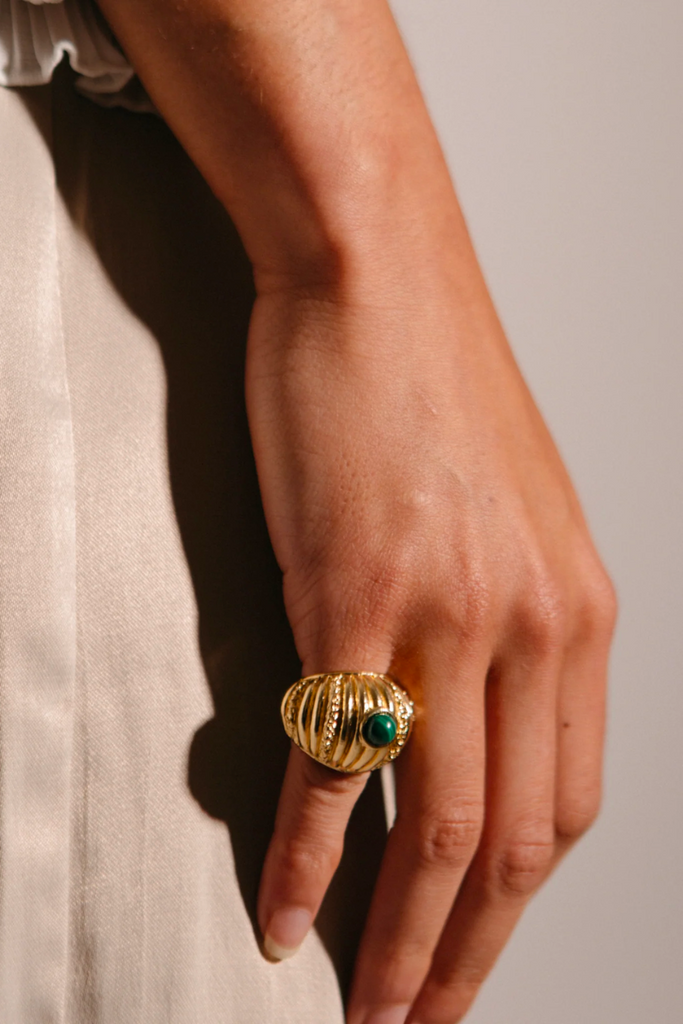 The Small Reef Ring from Paola Sighinolfi is a handcrafted, 18kt gold-plated organic ring inspired by coral gardens and featuring a green stone that exudes regal elegance and tranquility, making it a timeless and elegant accessory perfect for any formal occasion.