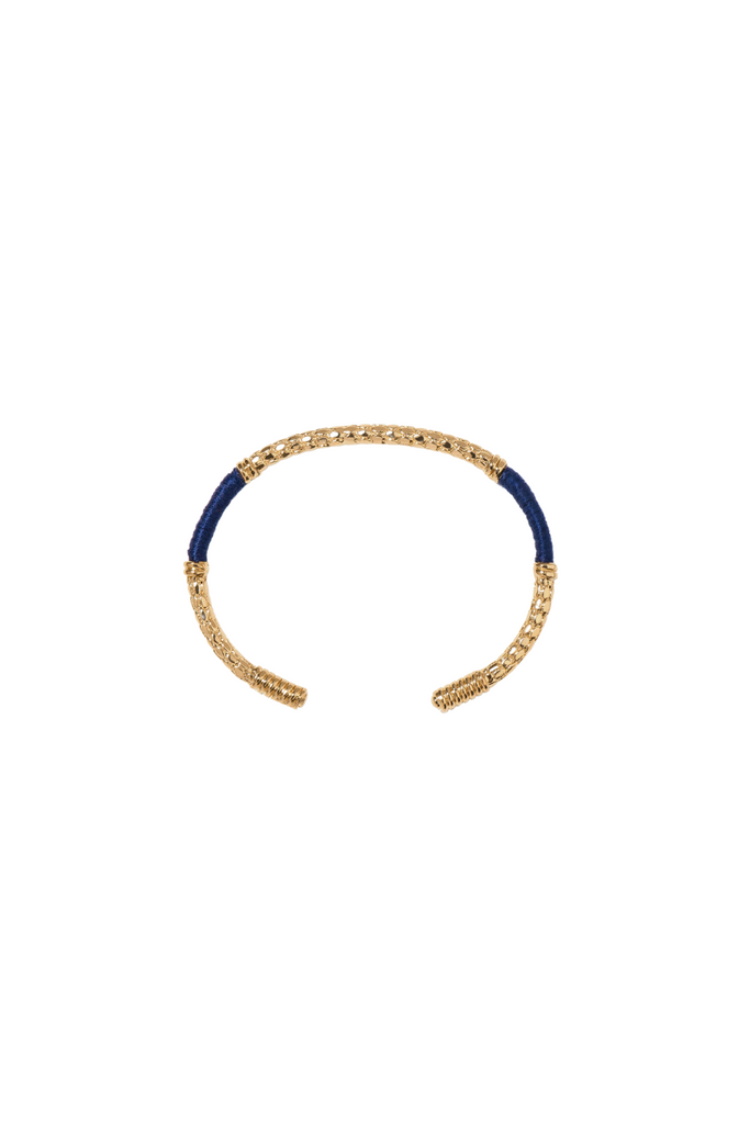 Indulge in the timeless beauty of the Aurelie Bidermann Blue Emerald Soho Bracelet. This stunning piece combines the warmth of gold with the coolness of blue cotton thread, creating a beautiful contrast that is both captivating and refined.