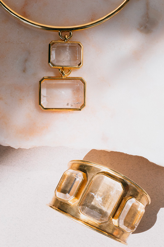 Make a statement with the elegant and sophisticated Stones Bracelet from Goossens Paris, featuring unique emerald-cut semi-precious stones and a 24-carat gold-soaked brass chain that exudes luxury and can be worn around the wrist, finger, or neck.