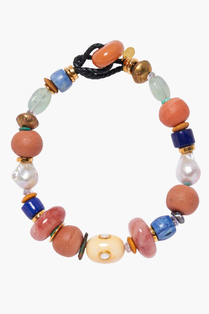 Discover a true treasure trove of eclectic elements with the captivating and bohemian-inspired Treasure Beach Collar by Lizzie Fortunato, featuring recycled glass, resin, bone, aquamarine, pink amethyst, turquoise, and pearl beads.
