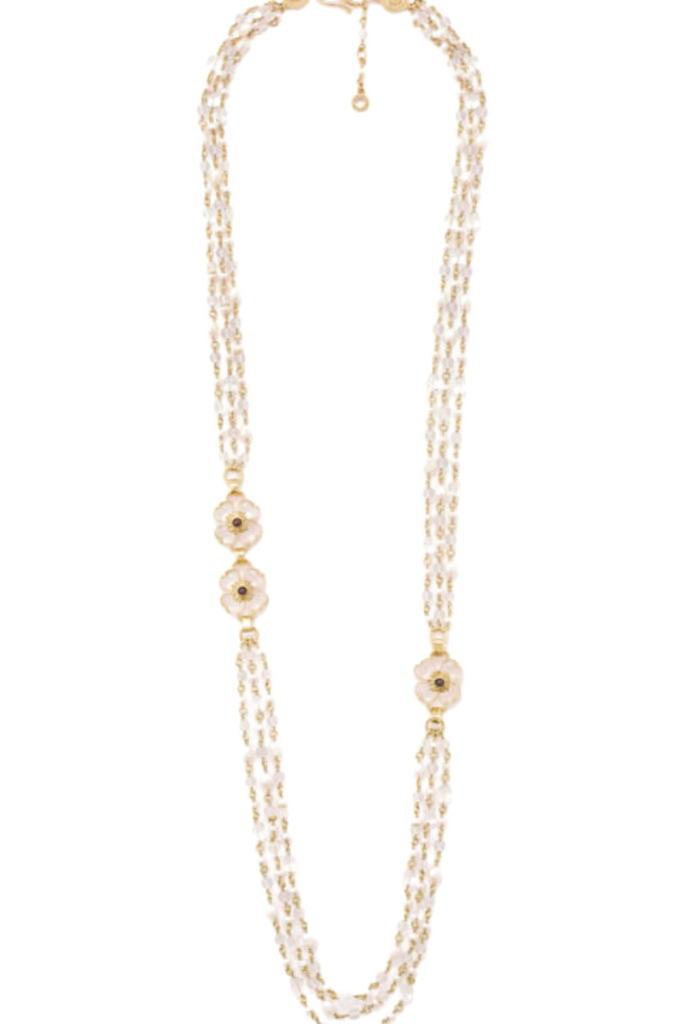 The Trefle Long Necklace by the House of Goossens is an exquisite and feminine lucky charm, featuring three clovers crafted from rock crystal stones, garnets, freshwater pearls, and rock crystal pearls on a 24-carat gold bathed brass chain.