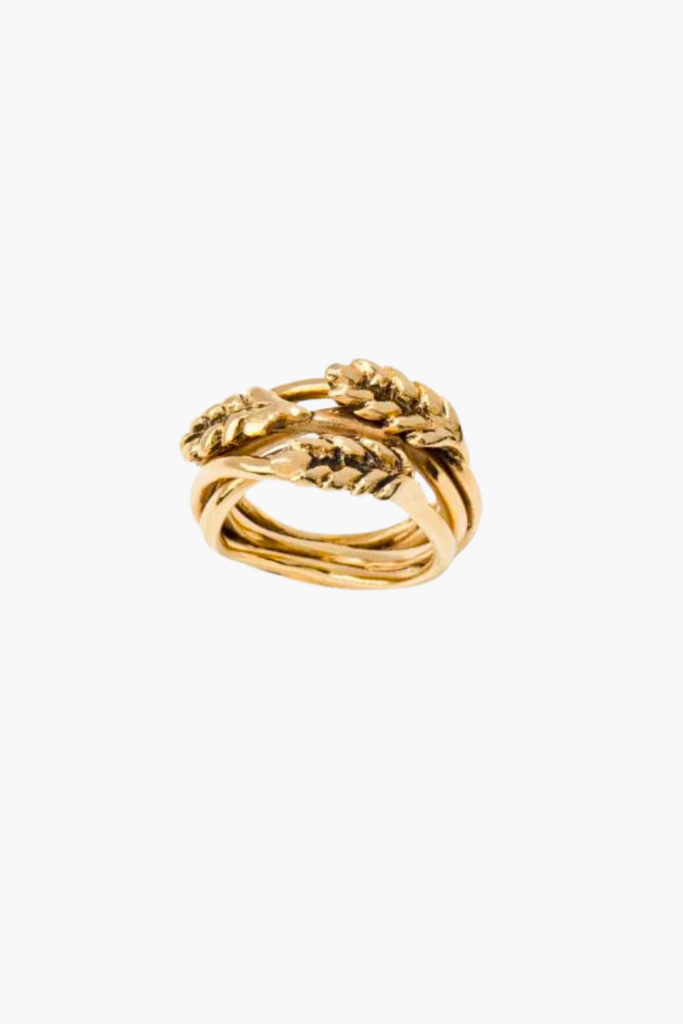 The "Bague Multi Épis de Blé" is an 18 karat yellow gold ring featuring multiple strands of golden wheat stalks intertwined, symbolizing prosperity and growth.